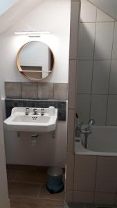 a bathroom with a sink and a mirror at Villa de 1926, plage de sable fin à 200m, proche commerces in Jullouville-les-Pins +63 photos