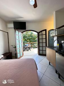 a kitchen with an open door to a patio at Casa Naturaleza in Ilhabela