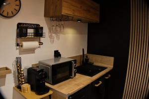 a kitchen with a microwave on a wooden counter at CocooningRoom - Tain L'hermitage in Tain-lʼHermitage
