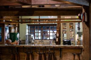 a bar in a restaurant with a counter with stools at Boqueirão Hotel Fazenda in Lages