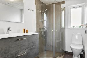 a bathroom with a shower and a toilet and a sink at LF12006-Handbjerg-Runddelen-6  +30 photos