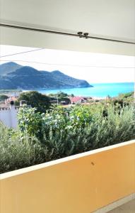 a window with a view of the ocean at Cactus Apartments - Sea View in Solanas