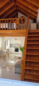 a living room with a staircase and a kitchen at Duchess House in Symi
