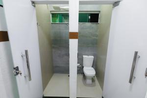 a bathroom with a toilet and a shower stall at torre forte apart hotel in Rio Branco