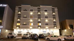 a large building with cars parked in front of it at شقق سكنة الرياض in Quai