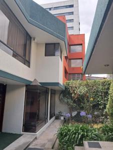 an external view of a building in a city at Cozy, fashionable and stylish room in Quito