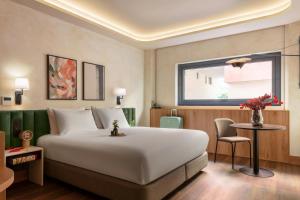 a bedroom with a large white bed and a window at Serenay Málaga Hotel in Málaga