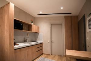 a kitchen with a sink and a counter top at IKIAN - Charming Arcadian Escape in Dimitsana