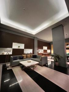 a living room with a couch and a table at Radiance Manila Bay Bayview Comfort with Pool & Pet-Friendly in Manila