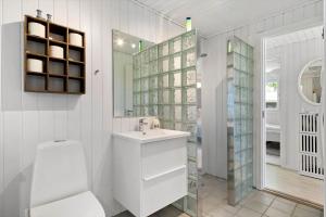 a white bathroom with a sink and a mirror at OH291-Hadsund-Mollevaenget-16 in Hadsund +26 photos