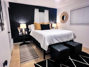 a bedroom with a bed and a black wall at Pristine Montrose Walkable Apt Half Block to Menil Museum in Houston