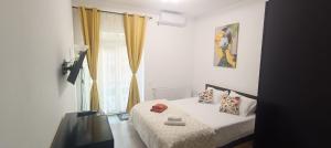 a bedroom with a bed and a window at Casa KIM in Eforie Nord