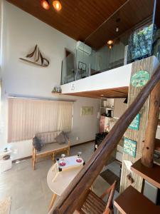 a living room with a couch and a loft at The Private Forest Lake Tinys Aruanda in Mata de Sao Joao