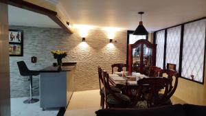 a dining room with a table and chairs at El Encanto de Sopo in Sopó