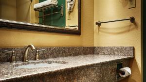 a bathroom with a sink and a mirror at Quality Inn & Suites - Marlin in Marlin