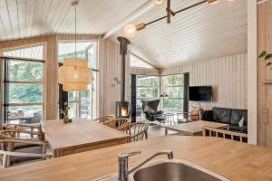 a kitchen and living room with a sink and a table at OH185-Hadsund-Sommerland-39 in Hadsund