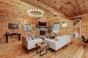 a living room with a couch and a fireplace at Deerwood in Ellijay