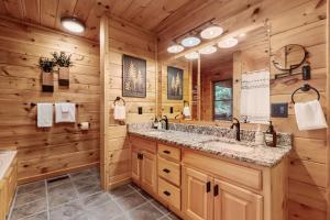 a bathroom with a large sink and a large mirror at Deerwood in Ellijay +26 photos
