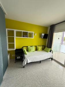 a bedroom with a bed and a yellow wall at 602 Cala Forn Salou Side sea views w Direct access to the beach in Salou