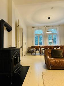 a living room with a stove and a couch at Design Villa Uckermark mit riesigem Garten in Ferdinandshof
