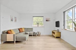 a living room with a couch and a tv at OH465-Hadsund-Havnovej-91 in Hadsund
