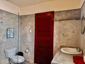 a bathroom with a toilet and a sink at Casa Zapata, Campeche in Campeche +38 photos