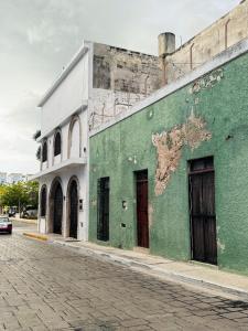 a green building on the side of a street at Casa Zapata, Campeche in Campeche