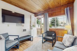 a living room with two chairs and a tv at Tranquil Shores Hideaway in Cle Elum