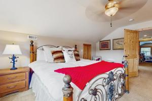 a bedroom with a bed with a red blanket on it at Tranquil Shores Hideaway in Cle Elum