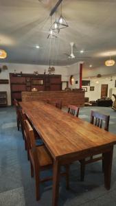 a large wooden table with chairs in a room at Waghill Presidential Penthouse in Mwanza