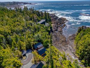 an aerial view of a house on a cliff next to the ocean at Fogged Inn in Ucluelet