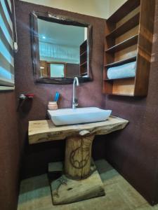 a bathroom with a sink and a mirror at Waghill Presidential Penthouse in Mwanza +30 photos