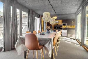 a dining room with a long table and chairs at OH376-Hadsund-Sommerland-56-a in Hadsund