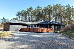 a house with a gravel driveway in front of it at OH376-Hadsund-Sommerland-56-a in Hadsund