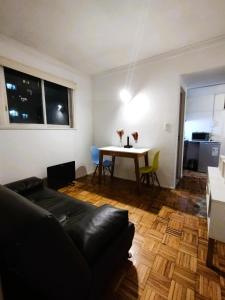 a living room with a couch and a table at Central y Comodo Departamento in Buenos Aires