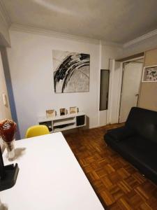 a living room with a table and a couch at Central y Comodo Departamento in Buenos Aires