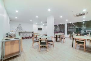 ein Restaurant mit Tischen und Stühlen in einem Raum in der Unterkunft Townhouse Sarjapur Near Bellandur in Bangalore + 38 Fotos