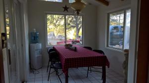 a dining room table with a red and white checkered table cloth at Secluded Oasis with Hot tub n firplace on 40 acres in Bodfish