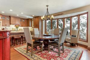 a kitchen and dining room with a table and chairs at Luxury Home with Private Hot Tub, Woodburning Fireplace, Pet Friendly in Vail