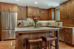 a kitchen with a center island with a vase of flowers at Luxury Home with Private Hot Tub, Woodburning Fireplace, Pet Friendly in Vail +23 photos