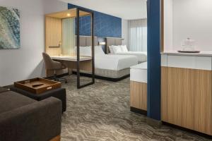 a hotel room with two beds and a living room at SpringHill Suites by Marriott Eau Claire in Eau Claire