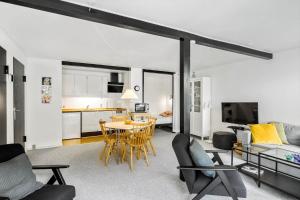 a living room with a table and chairs and a kitchen at 5514-Gudhjem-Holkavej-2-Lejl-3 in Gudhjem