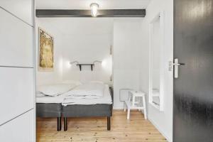 a small bedroom with a bed in a room at 5514-Gudhjem-Holkavej-2-Lejl-3 in Gudhjem +19 photos