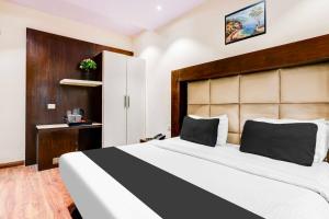 a bedroom with a large bed with a black and white blanket at Townhouse DLF Phase 2 Gurgaon in Gurgaon
