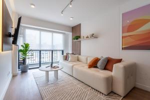 a living room with a couch and a table at Exclusive Mariano Santos 179 Residences by Geko in Lima
