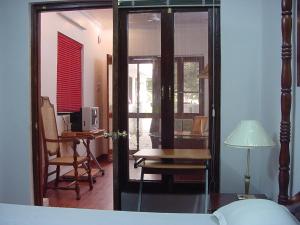 a bedroom with a bed and a desk and a table at Petite Homestays in New Delhi
