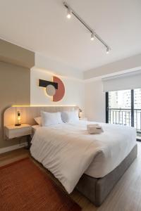 a large white bedroom with a large bed and a window at Exclusive Mariano Santos 179 Residences by Geko in Lima