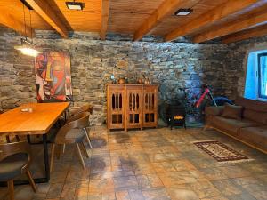 a living room with a table and a stone wall at Ghebi Inn in Oni