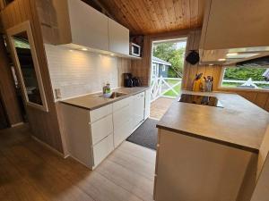 een keuken met witte kasten en een groot raam bij 7 person holiday home in Vestervig-By Traum in Vestervig +31 foto's