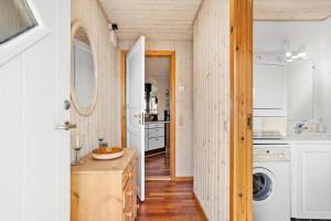 a kitchen with white cabinets and a washer and dryer at FY130-Middelfart-Stjernevej-117 in Middelfart